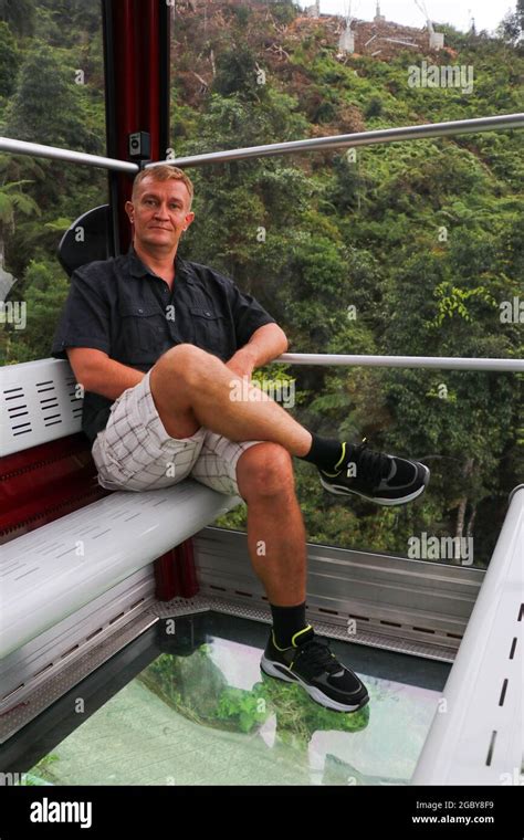 Land Viewed Through The Glass Floor Of A Crystal Cabin Man In Cable Car Cabin With Glass Floor