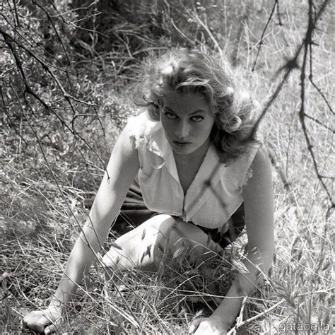 Black And White Photograph Of A Woman Kneeling In The Grass