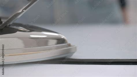 Close Up Of A Fashion Designer Girl With Her Hands Ironing Clothes With