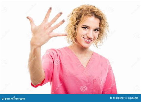 Portrait Of Nurse Wearing Pink Scrub Showing Number Five Stock Image