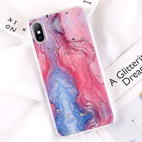 A Pink And Blue Liquid Phone Case Sitting On Top Of A White Table Next