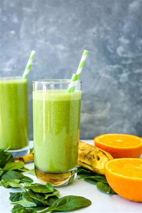 A Spinach Smoothie With Fresh Oranges Spinach And A Banana On The Table Spinach Smoothie