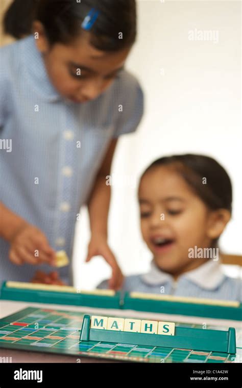 Kids playing scrabble game Stock Photo - Alamy