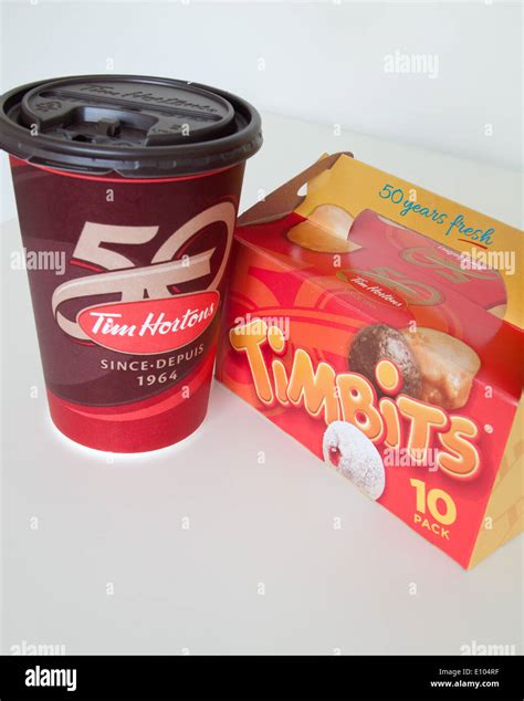 A Tim Hortons coffee cup and Timbits (doughnut holes, donut holes ...