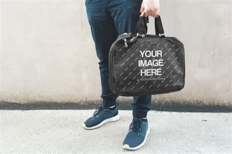 Man Holding Black Laptop Bag Mockup - Mediamodifier