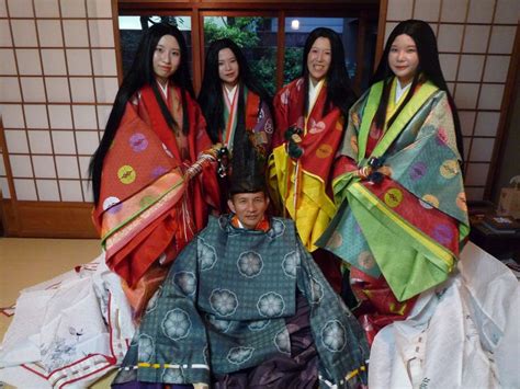 A Man And A Group Of Women Dressed In Heian Era Robes At A Junihitoe