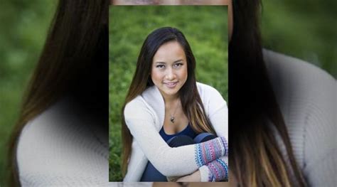 a woman with long brown hair is smiling