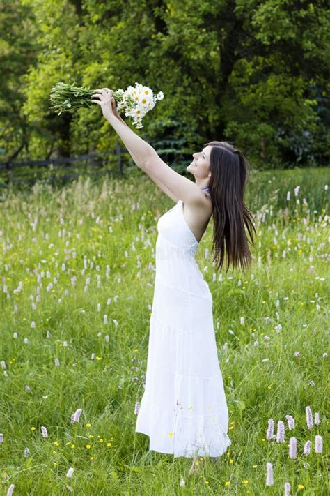 Beautiful Girl Holding Flowers In A Meadow Stock Image Image 19869297