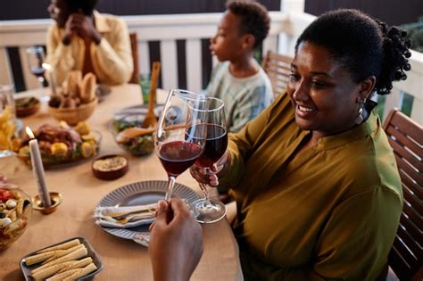 Premium Photo Side View Portrait Of Smiling Black Woman Clinking Wine