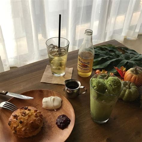 a wooden table topped with food and drinks