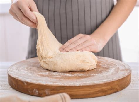 Premium Photo Woman Kneading Dough On Kitchen Table