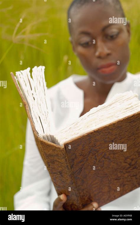 African American Woman Reading Book Outdoors Stock Photo Alamy