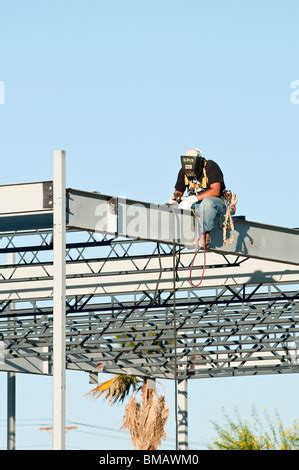 Steelworker Welds The Structural Steel Framework For A Commercial