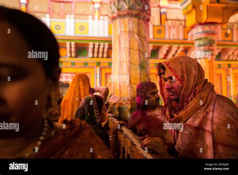 man covered  gulal  colored water  dwarkadhish temple