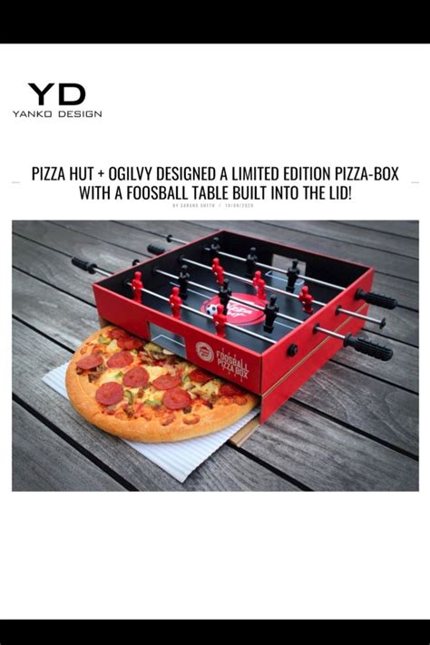 A Pizza Sitting On Top Of A Table Next To A Foosball Style Game