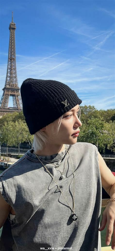 A Woman In Front Of The Eiffel Tower With Her Hand On Her Hip