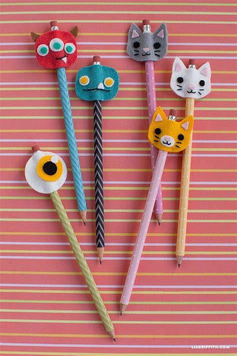 Four Different Colored Toothbrushes With Cats And Flowers In Them On A