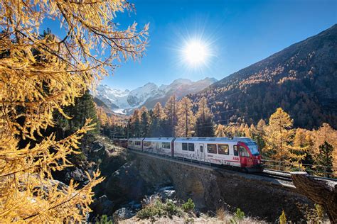 Tourist train on the swiss alps passes through mountains 4192206 Stock