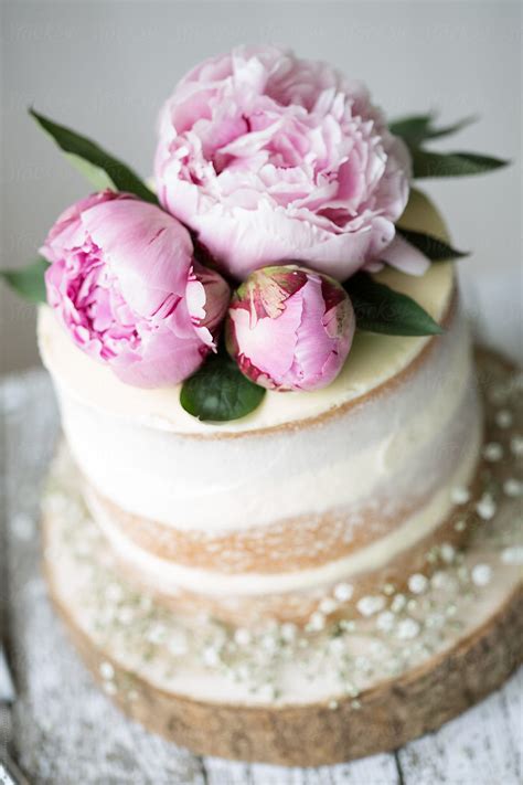 Naked Wedding Cake Decorated With Fresh Flowers By Stocksy