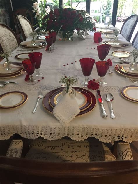 The Table Is Set With Red And White Dishes