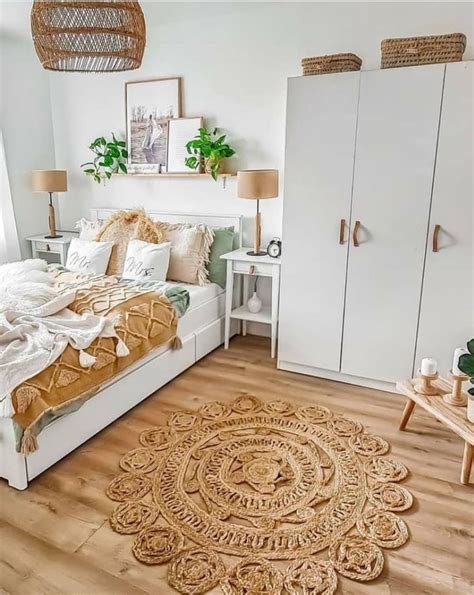 A Bedroom With White Walls Wooden Floors And An Area Rug On The Floor