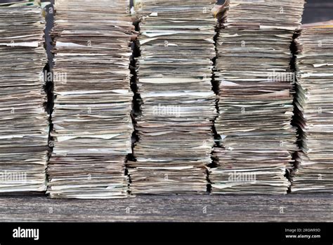 a large amount of old crumpled and dirty money, stacked in huge piles ...