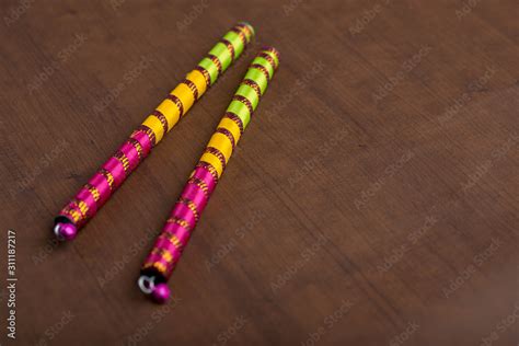 Dandiya sticks on a brown background. Raas Garba or Dandiya Raas is the ...