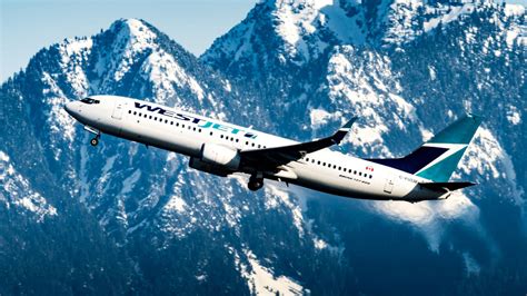 Download Westjet Airline Plane Over Mountains Wallpaper