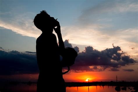 Premium Photo Silhouette Man Smoking Cigarette Against Sky During Sunset