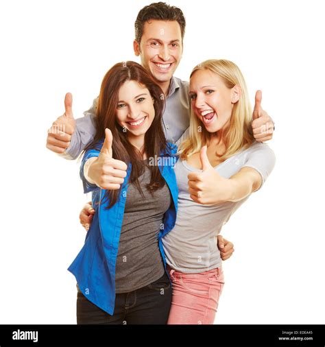 Three happy young people cheering and holding their thumbs up Stock Photo - Alamy