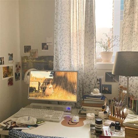 A Desktop Computer Sitting On Top Of A White Desk Next To A Lamp And Window