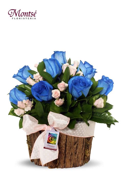 a bouquet of blue roses in a wooden box