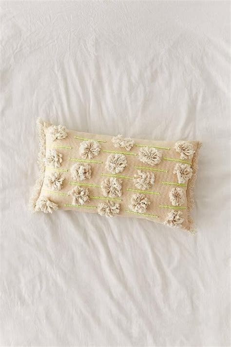 A Pillow With Flowers On It Laying On A Bed