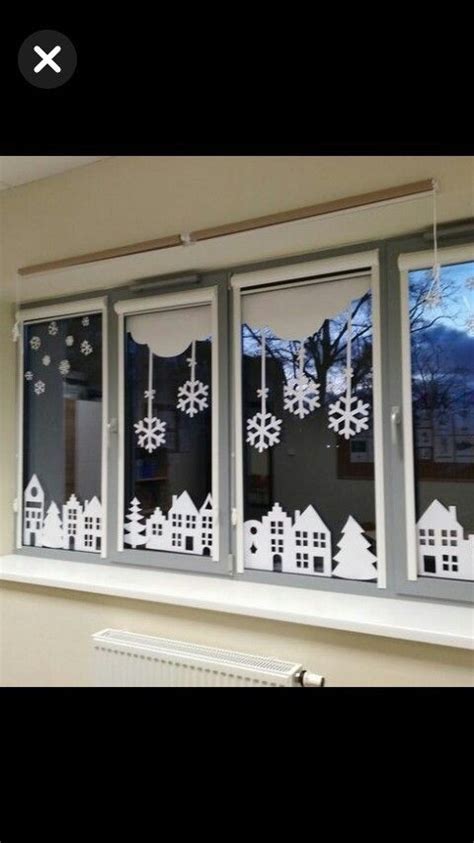 The Window Is Decorated With Snowflakes And Christmas Decorations