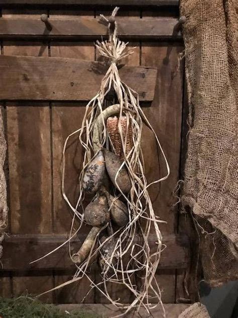 A Bunch Of Potatoes Hanging From A Rope On A Wooden Wall Next To Burlocks