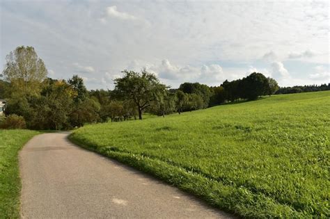 Premium Photo Road Amidst Field Against Sky