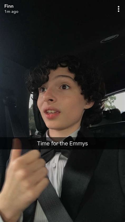 A Woman Sitting In The Back Seat Of A Car Wearing A Bow Tie And Looking Up