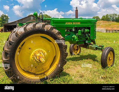 John Deere Tractor By Old Barn Stock Photo Alamy