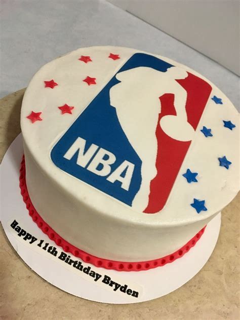 A Birthday Cake That Is Decorated With The Logo Of The Basketball Team