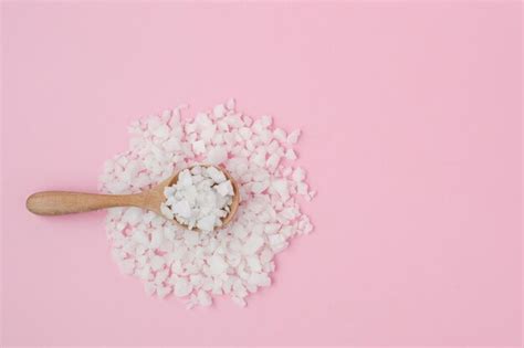 Premium Photo Sea Salt In A Wooden Spoon On Pink Background For