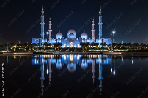 Grand Mosque in Abu Dhabi at night in the United Arab Emirates (UAE) in a Reflective Pond ...