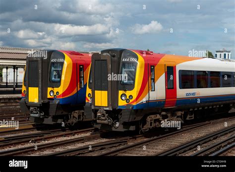 Class 450 and class 444 passenger trains in South West Trains livery at Clapham Junction ...