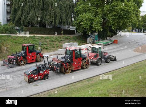 Red asphalt paving machines such as street rollers and wheel dozer ...