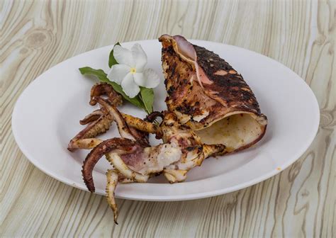 Grilled Cuttlefish On The Plate And Wooden Background 12472664 Stock