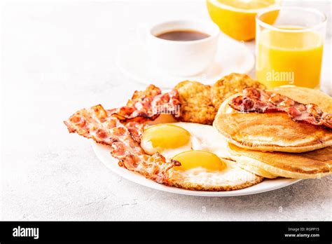 Healthy Full American Breakfast With Eggs Bacon Pancakes And Latkes