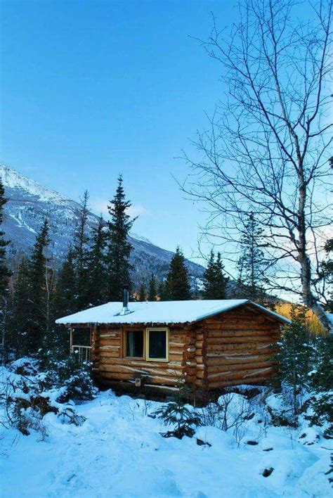 A Snow Covered Cabin In The Mountains Small Log Cabin Tiny House