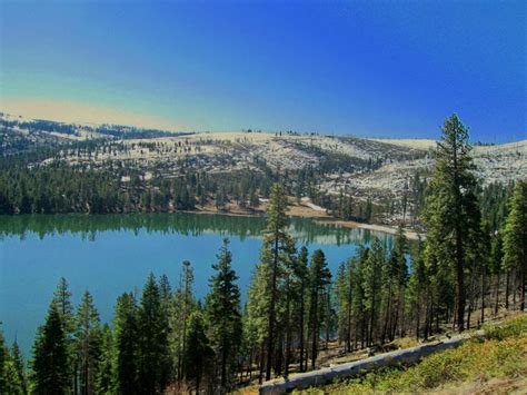 Blue Sky And Snow Covered Hills Surround Blue Lake Modoc National