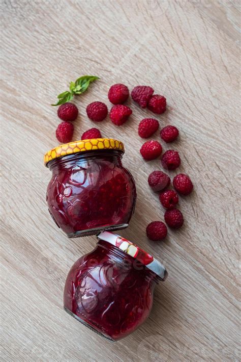 Raspberries spread over a jar of jam 50104577 Stock Photo at Vecteezy