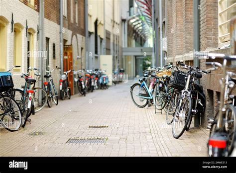 Many Bicycles Parked On The Street Of Amsterdam Netherlands Typical