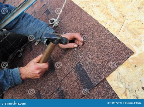 Roofer Install Asphalt Roof Shingles. Close Up View on Roofer ...